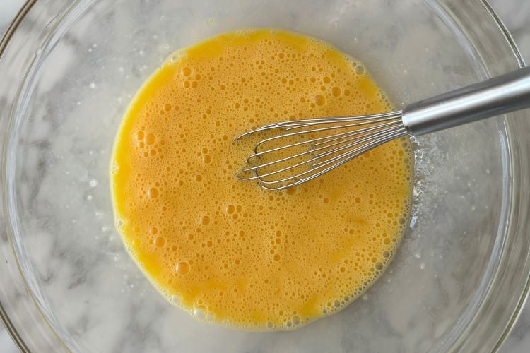 Whisked eggs in a large bowl