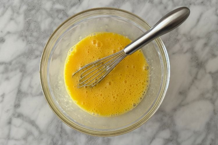 Whisked eggs in bowl