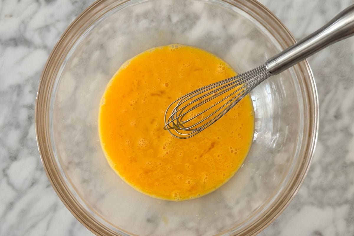 Whisked eggs in a large bowl for quiche