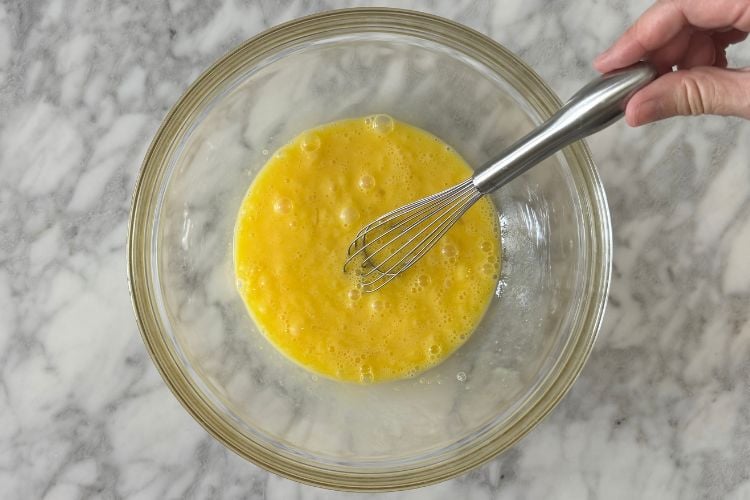 Whisked eggs in large bowl