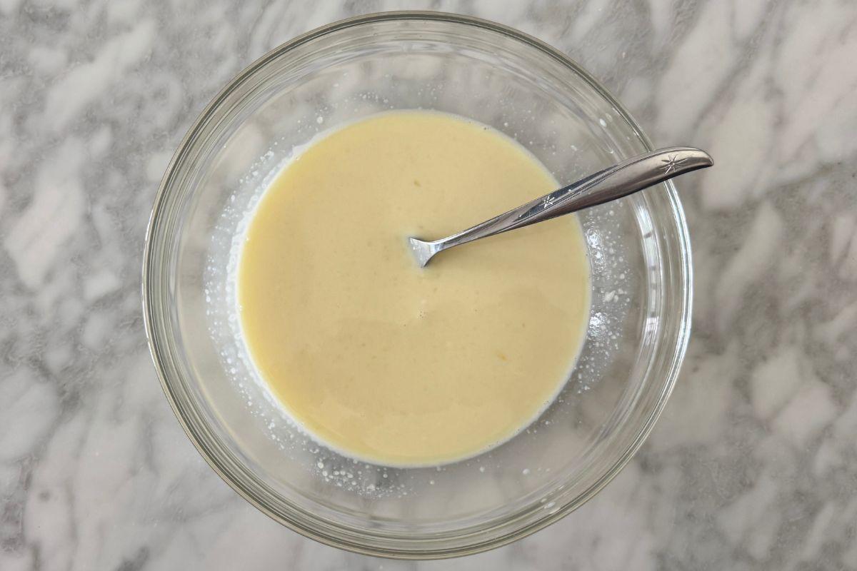 Whisked wet ingredients for cornbread in bowl