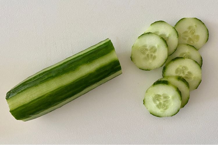 chopped cucumber on board
